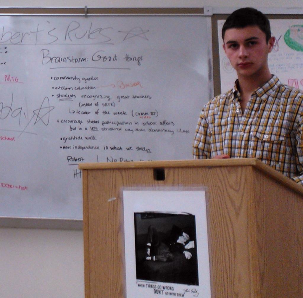 Senior Robby Rocchio at the podium during a Student Union meeting