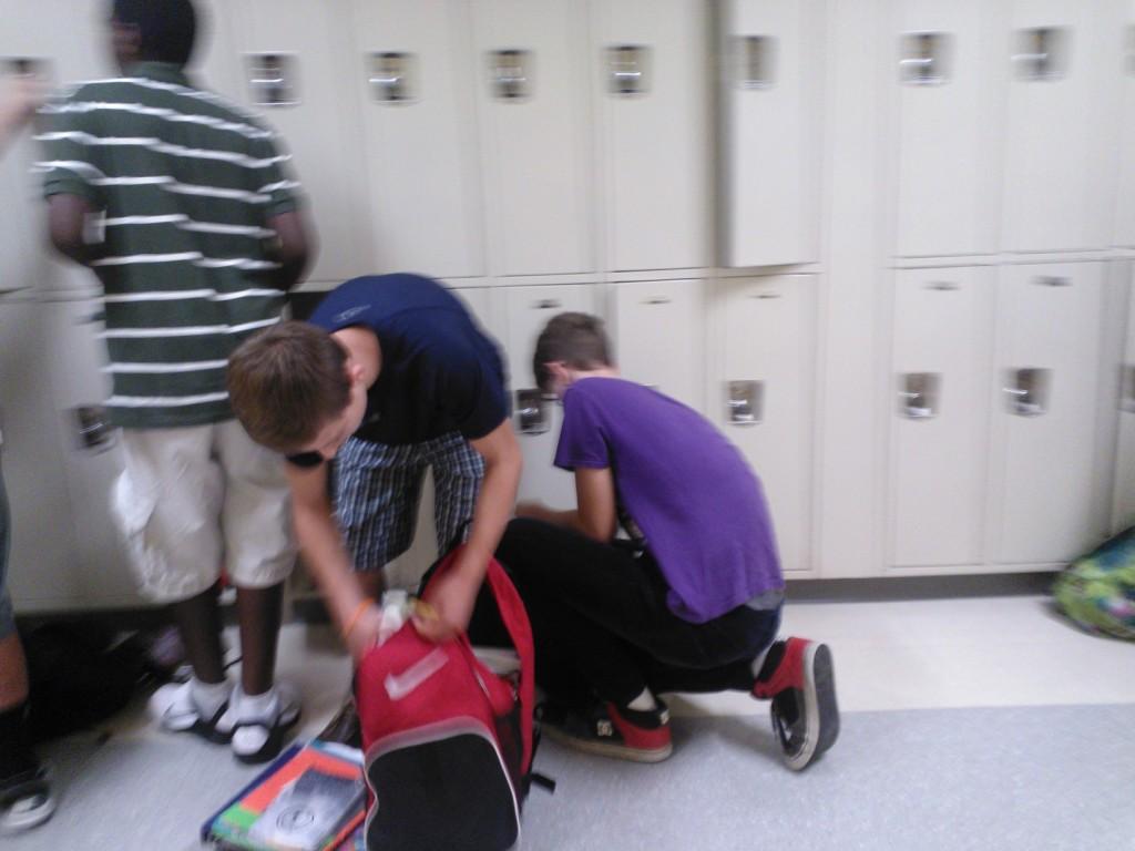 Students retrieve their belongings from their lockers during passing time