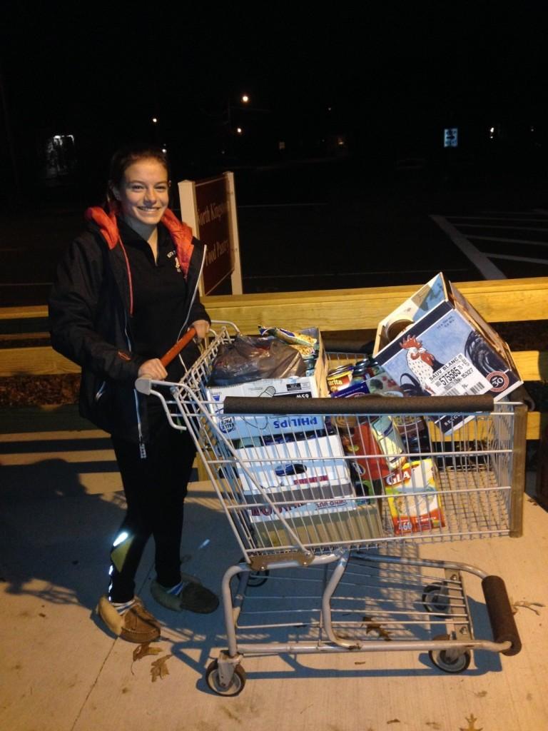 Senior Sofia Greco-Byrne drops off a carriage full of food to the Food Bank. 