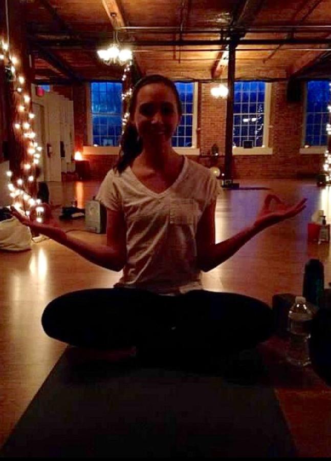 Junior Abby Moretti at a yoga classs at Lotus Fire Yoga & Healing in North Kingstown