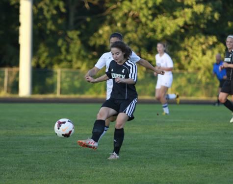 Sarah Andrews passes the ball to a teammate during an NKHS varsity soccer game. 
