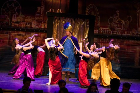 Ivy Smith (Laura Vanasse) and girls of the ensemble dance around the dance hall owner (Dan Cook).