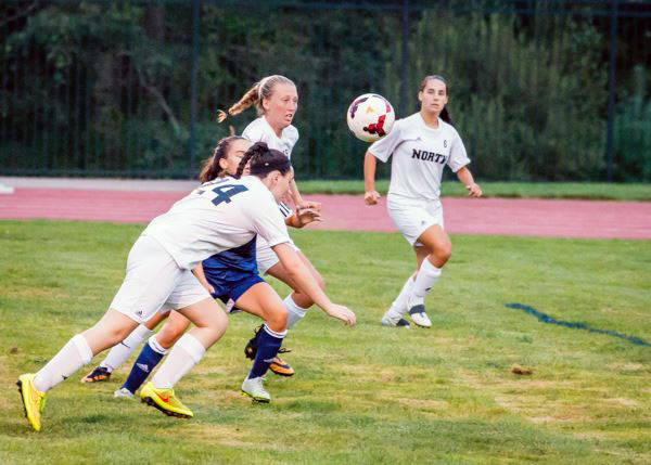 Senior Shannon Coleman and junior Brooke Osmanski compete for a head ball against a defender. Both players suffered concussions in this soccer season.