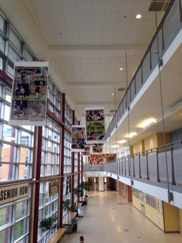 Signs that hang over senior row spell out "pride". 