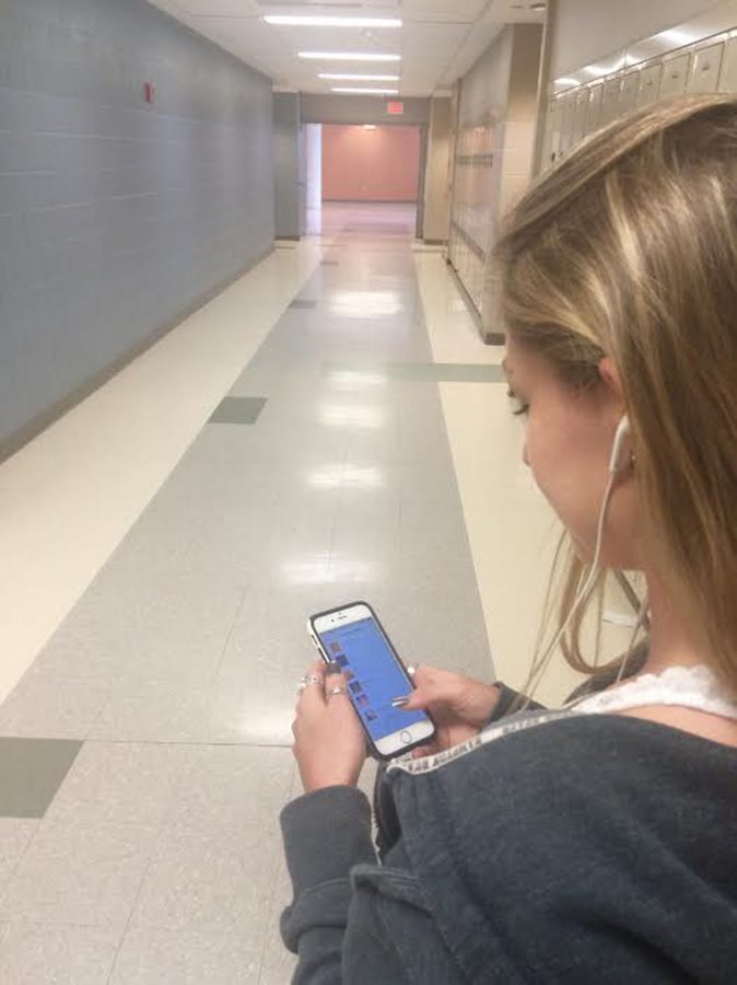 Senior Alicia Southland listens to music in the hallways of NKHS.