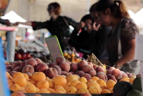 Shoppers at the Farmers Market in Long Beach, Calif., browse through fresh apricots, cherries and peaches on Friday, May 8, 2015.
