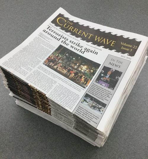 A stack of newspapers sits ready for delivery.