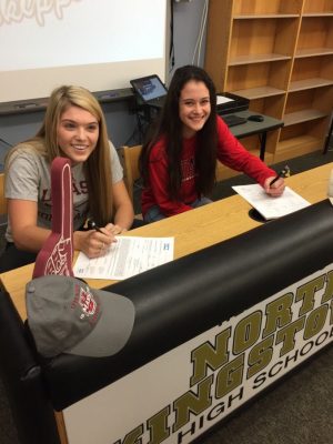 Seniors Kiara Oliver, left, and Meg Maguire, right, sign their National Letters of Intent during a ceremony in November.  Maguire and Oliver are two of the six seniors who will be competing at the Division 1 level next year. 