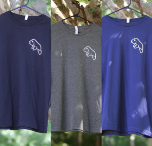 Bruce Coppola, Mike Madoian, and Joe Piacitelli sell their Mana-tee shirts in a variety of colors. 